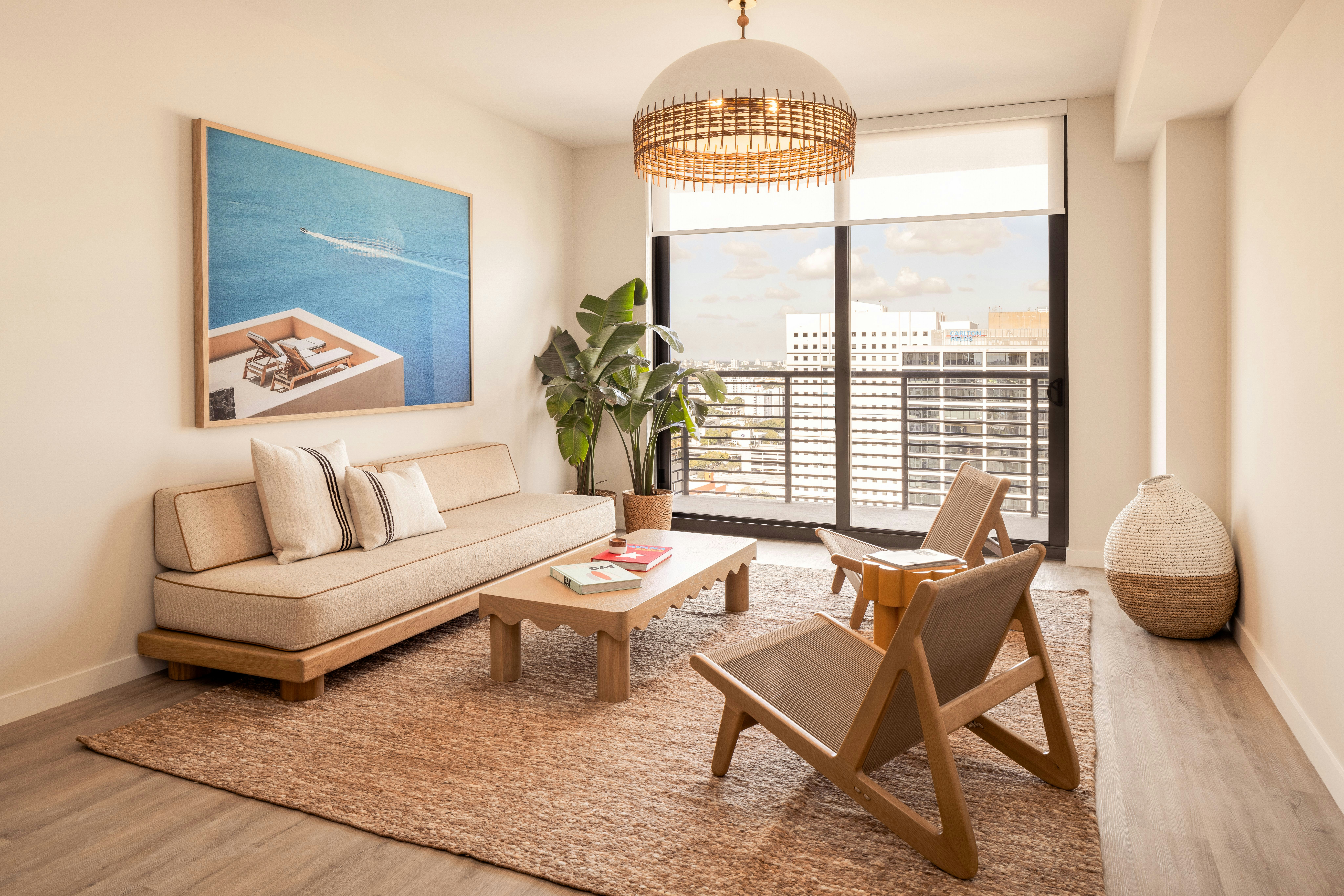 Sunlit modern living room with luxury furniture and indoor plant