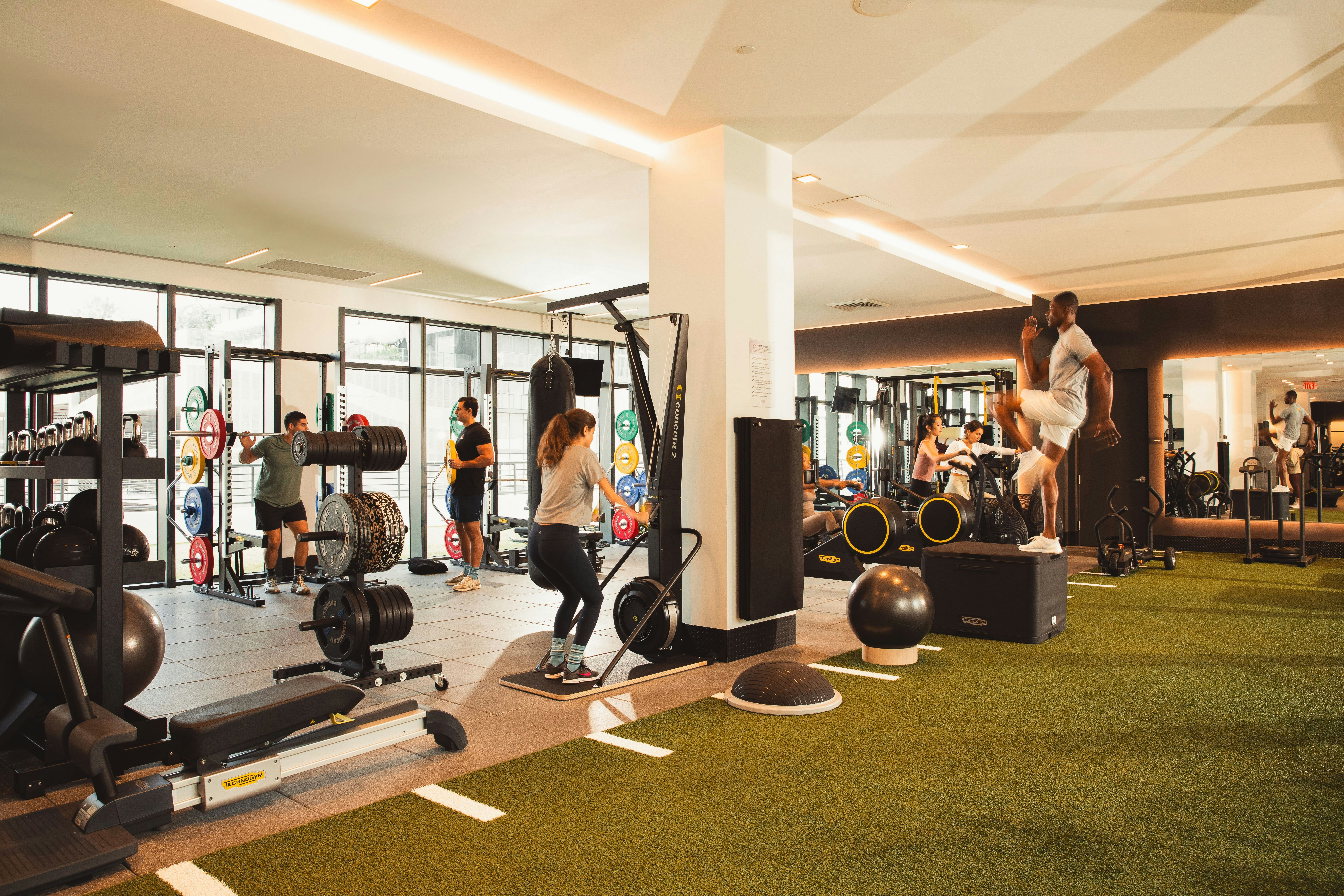Group workout session in spacious gym with modern equipment